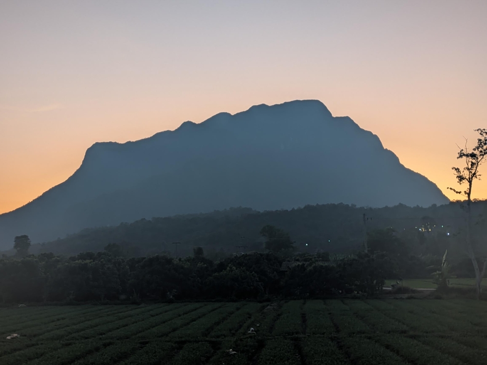The shadow of a flat top mountain at sunset.